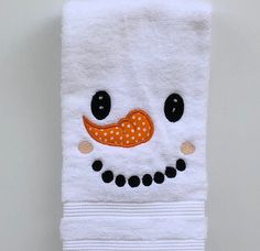 a white towel with an orange nose and polka dot dots on it's face