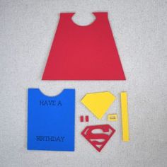 paper cutouts and craft supplies for a superman birthday party