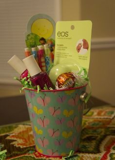 a cup filled with lots of different items on top of a table