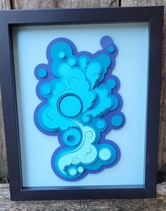 a framed paper cut out of a blue teddy bear