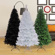 three different types of christmas trees in a living room