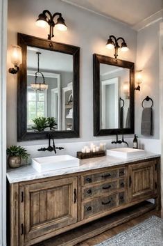 a bathroom with two sinks, mirrors and lights on the wall above them is shown