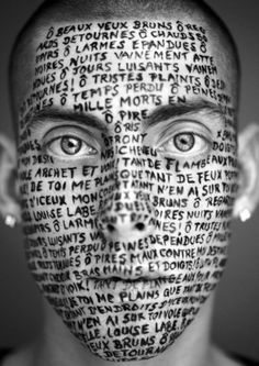 a man's face with words all over it and the word written on his face