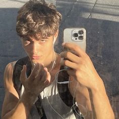 a young man taking a selfie with his cell phone