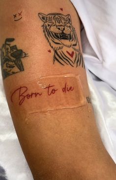 a person with a tattoo on their arm that says born to die and has an image of a tiger