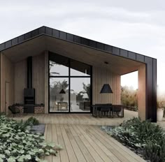 a small house with wooden floors and black accents on the roof is surrounded by greenery