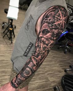 a man with a full sleeve tattoo on his arm