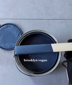 a person holding a paint can with the words brooklyn voque painted on it