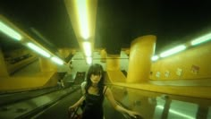 a woman is riding an escalator with her luggage