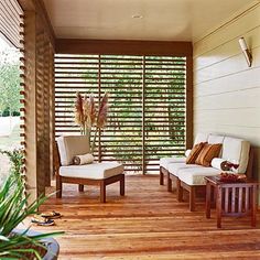 two white chairs sitting on top of a wooden floor next to a window covered in blinds