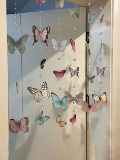 there are many butterflies hanging on the wall