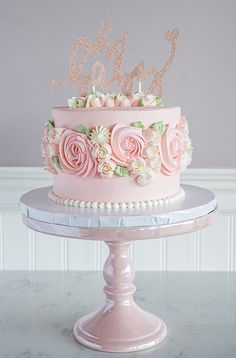 there is a pink cake with flowers on it