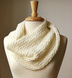 a white knitted scarf on a mannequin