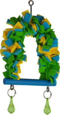 a green and yellow wreath hanging from a hook on a blue pole with two bells