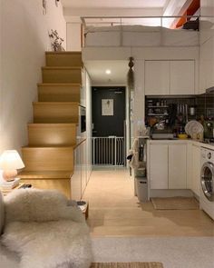 the stairs lead up to the kitchen and living room in this small apartment with white walls