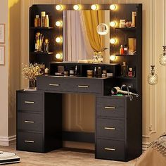 a vanity with lights on it in a bedroom next to a bed and dresser under a mirror