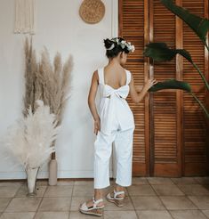 a woman standing in front of a plant