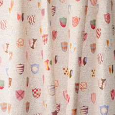 a close up of a curtain with many different designs on it