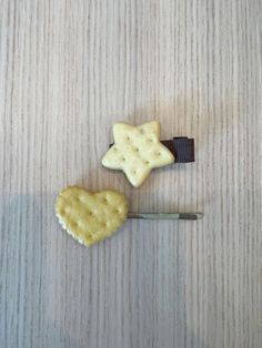 two cookies shaped like stars sitting on top of a table next to a toothbrush