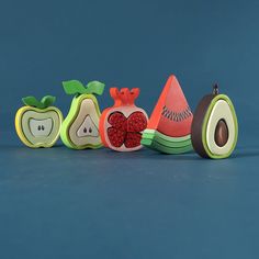 an apple, watermelon and kiwi slice cut in half on a blue background