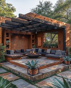 an outdoor living area with couches, tables and potted plants