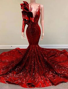 a mannequin wearing a red dress with sequins on it