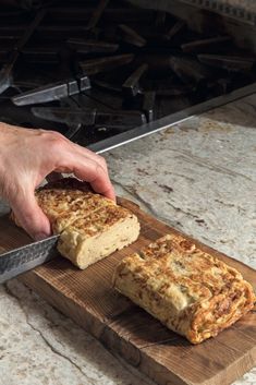 someone is cutting up some food on a wooden board