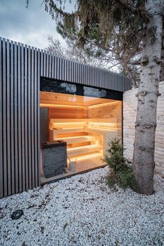 an open garage with stairs leading up to the top floor and doors on both sides