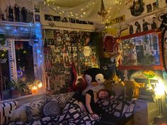 a person laying on top of a bed in a room with many pictures and lights