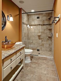 a bathroom with a sink, toilet and shower