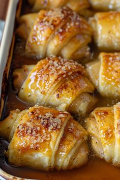 baked pastry items in a baking dish ready to be eaten with sauce and seasoning