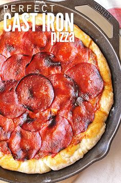 a pepperoni pizza sitting in a pan on top of a stove with the words perfect cast iron pizza