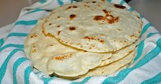 three pita breads on a blue and white towel