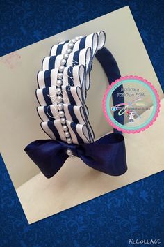 there is a blue and white hair bow with pearls on it