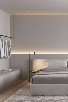 a bedroom with a large bed and white walls