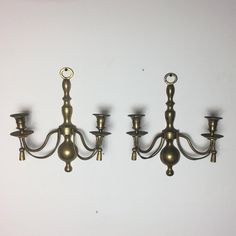 three antique brass candelabra lights on white background