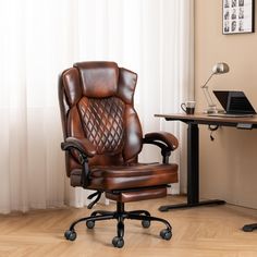 a brown leather office chair sitting in front of a desk with a laptop on it