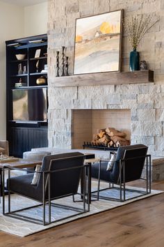 a living room filled with furniture and a fire place in front of a stone fireplace