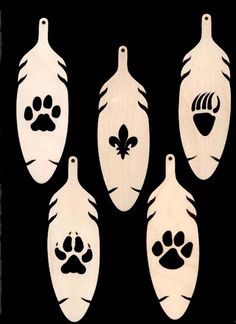 four wooden spoons with paw prints on them