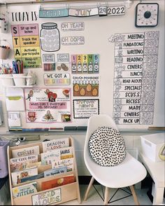 a white chair sitting in front of a bulletin board with writing and pictures on it