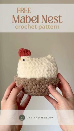 two hands holding up a crocheted cupcake with a chicken on top and the words free mabel nest crochet pattern above it