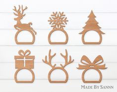 wooden cutouts with christmas decorations and deers on them, sitting next to each other