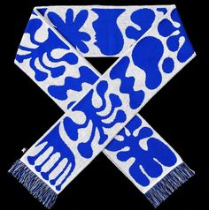 a blue and white scarf with an animal design on it's side, against a black background