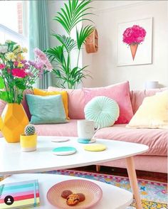 a living room filled with lots of furniture and colorful accessories on top of a white coffee table