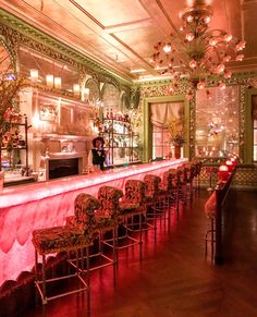 an image of a fancy restaurant setting with red lighting and chandeliers on the ceiling