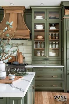 a kitchen with green cabinets and white counter tops