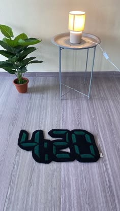 a floor mat with the number twenty five on it next to a potted plant