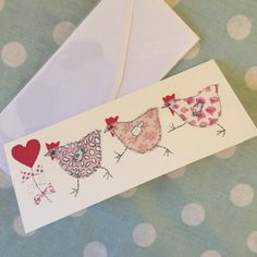 two envelopes with birds and hearts on them sitting next to an envelope that says i love you