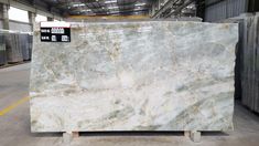 a large marble slab in a warehouse with no one around it or on the floor