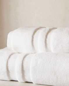 five white towels stacked on top of each other